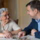 Senior Looking at Photos with Family Member