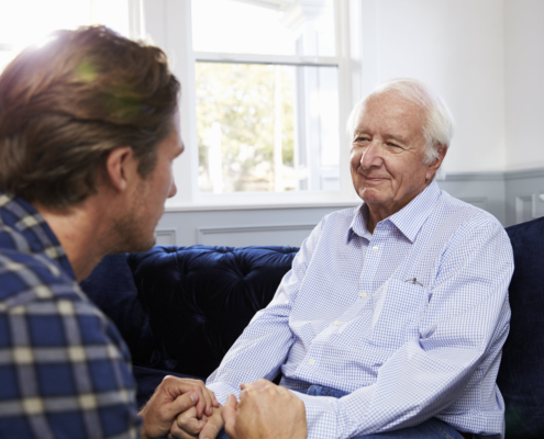 Son Speaking with Senior Parent