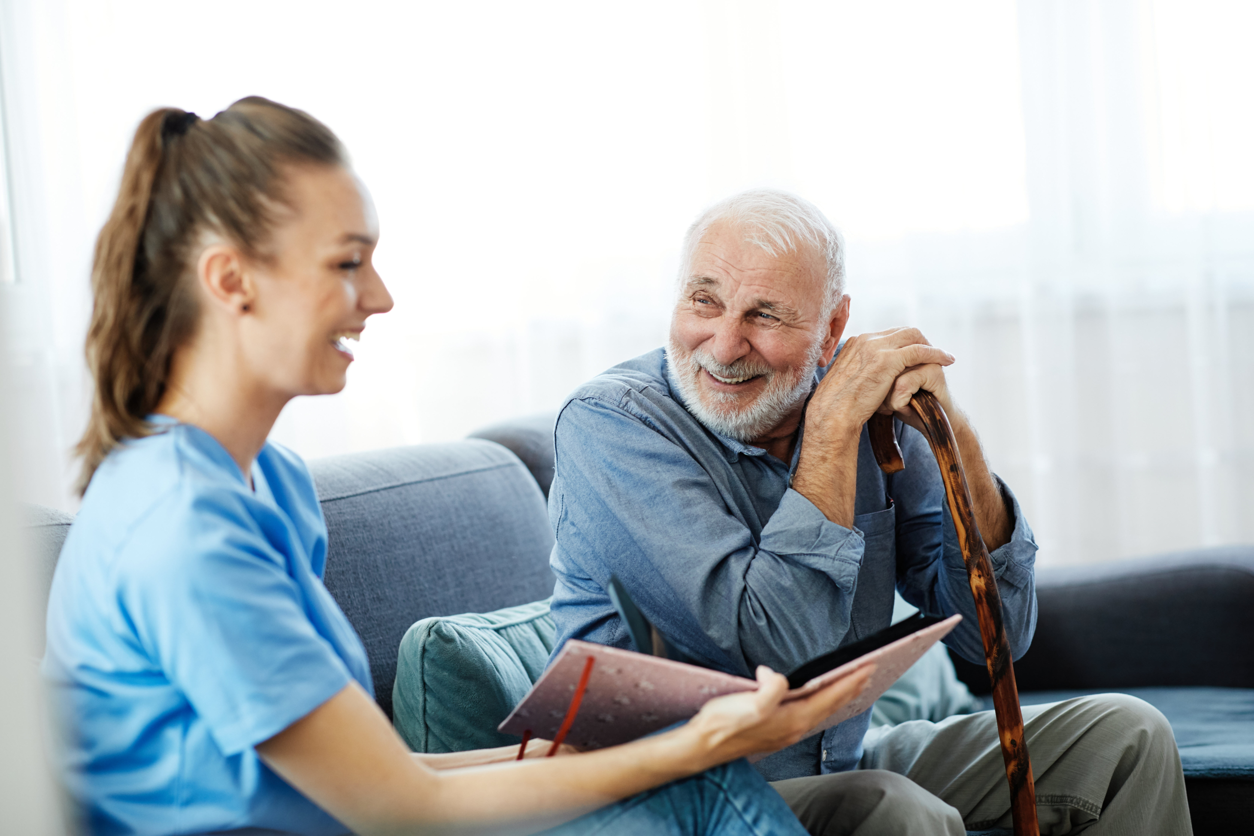 Caregiver lauging with memory care resident