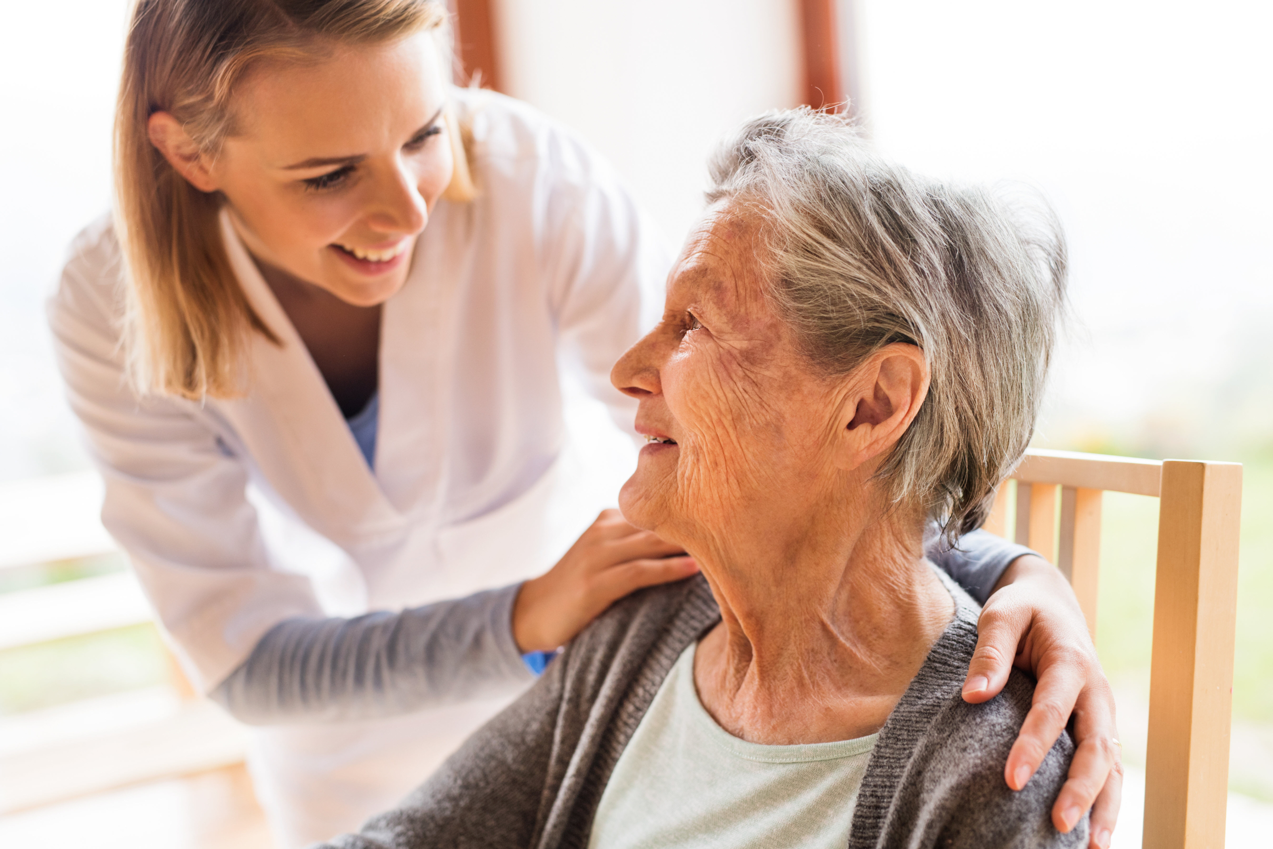 Older adults and caregiver interacting in a cozy assisted living community in Orange County.