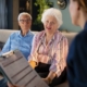 Older couple meets with a senior living advisor to review admission paperwork and assisted living community fee refund policies.